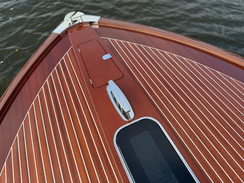 Slide: The Image of 2015 Riva Aquariva Super boat with polished wood deck on water. - 18