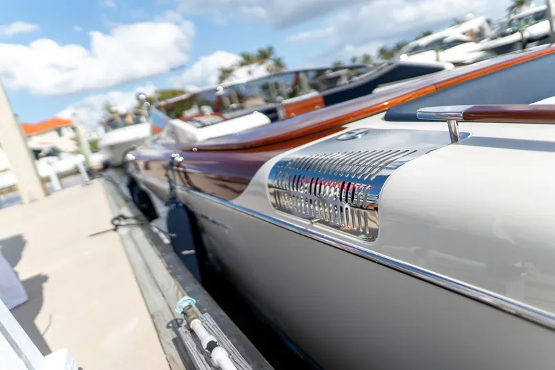 Slide: The Image of 2015 Riva Aquariva Super luxury boat docked under a sunny sky. - 20