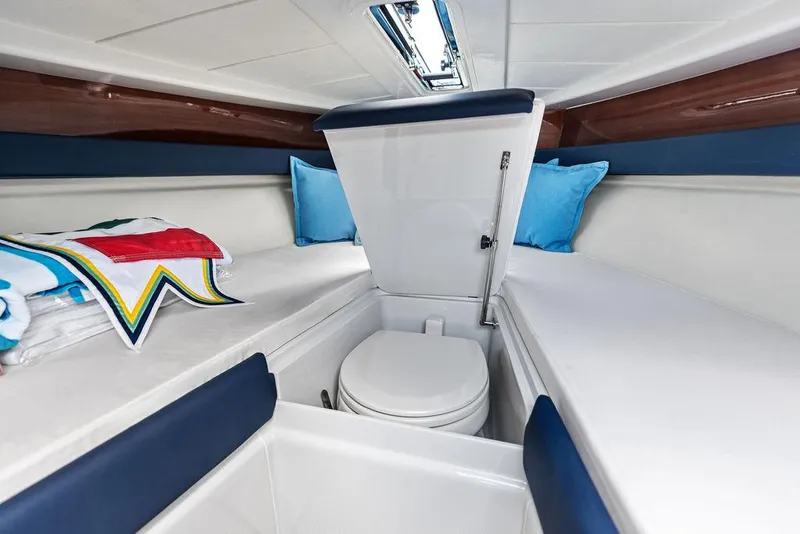 Slide: The Image of 2015 Riva Aquariva Super cabin interior with toilet, blue cushions, and colorful towels. - 25