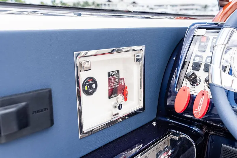 Slide: The Image of Control panel of a 2015 Riva Aquariva Super boat with key fobs and switches. - 31