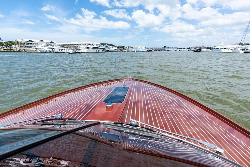 Slide: The Image of 2015 Riva Aquariva Super cruising on a sunny day, showcasing elegant wooden deck design. - 40