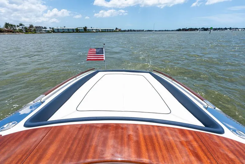 Slide: The Image of 2015 Riva Aquariva Super boat on water, American flag, sunny day. - 42