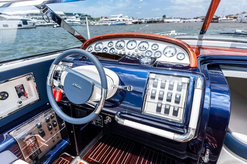 Slide: The Image of Interior of a 2015 Riva Aquariva Super boat, featuring a sleek dashboard and steering wheel. - 45