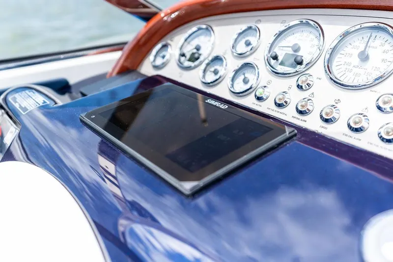 Slide: The Image of Dashboard of a 2015 Riva Aquariva Super with gauges and a navigation screen. - 49
