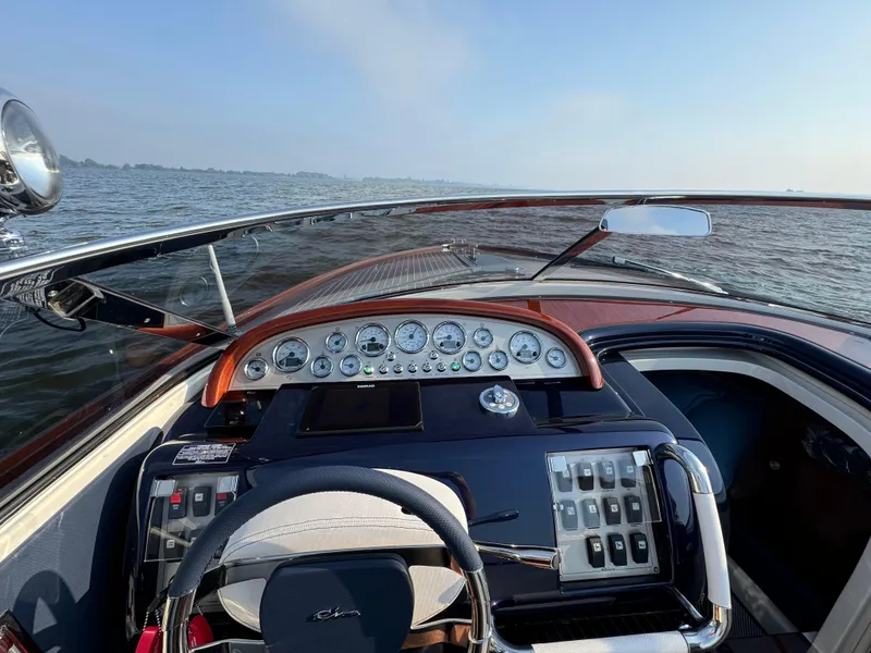 Slide: The Image of Cockpit view of 2015 Riva Aquariva Super boat with classic dashboard and steering wheel. - 10