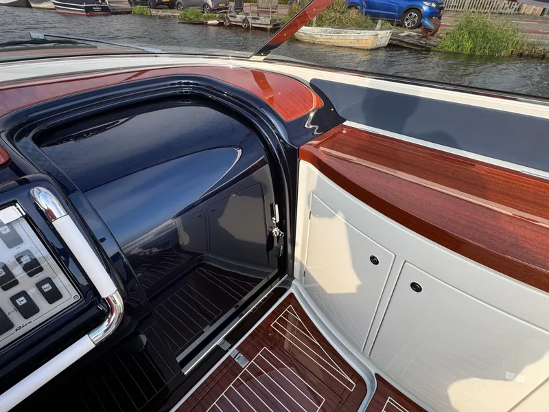 Slide: The Image of Interior view of a 2015 Riva Aquariva Super boat with elegant wood and leather finishes. - 17