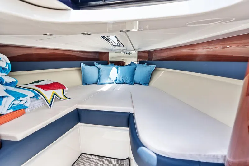 Slide: The Image of Interior cabin of 2015 Riva Aquariva Super with blue cushions and white seating. - 24