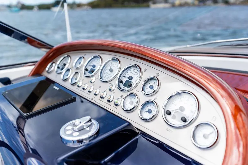 Slide: The Image of Dashboard of a 2015 Riva Aquariva Super boat with gauges and controls. - 33