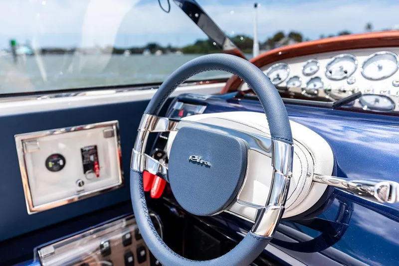 Slide: The Image of Steering wheel of a 2015 Riva Aquariva Super boat with dashboard controls. - 37