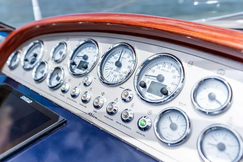 Slide: The Image of Dashboard of a 2015 Riva Aquariva Super boat with gauges and controls. - 48