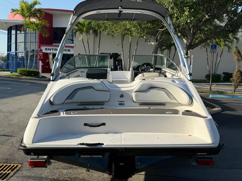 Slide: The Image of 2017 Yamaha AR190 boat with sleek design, parked outdoors near a modern building. - 17