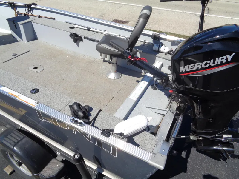 Slide: The Image of 2023 Lund 1600 Alaskan Tiller boat with Mercury engine, featuring a spacious interior. - 11