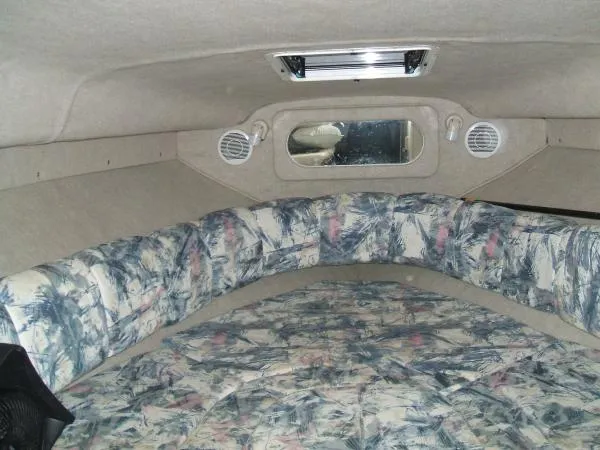 Slide: The Image of 1998 Sea Ray 270 Sundancer cabin interior with patterned upholstery and ceiling hatch. - 2