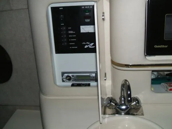 Slide: The Image of 1998 Sea Ray 270 Sundancer control panel and sink area. - 8