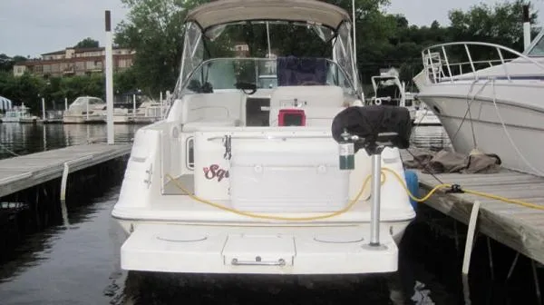 Slide: The Image of 1998 Sea Ray 270 Sundancer docked at marina, rear view with canopy and equipment. - 9