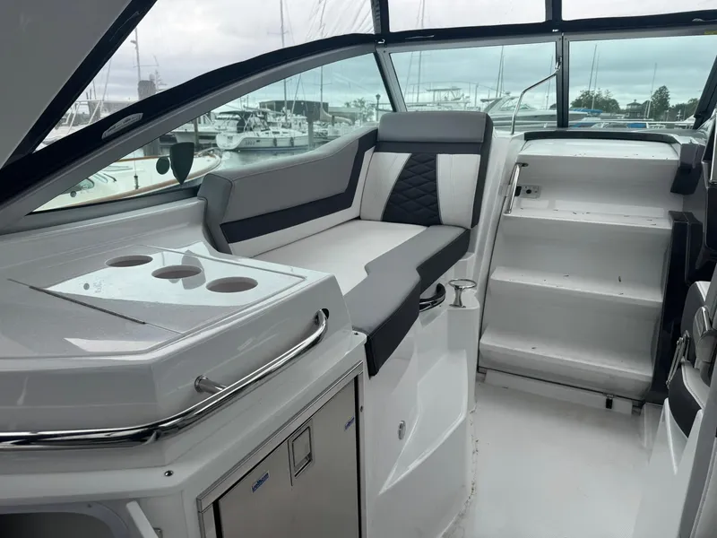 Slide: The Image of 2020 Monterey 295 Sport Yacht interior with sleek seating and modern design. - 11