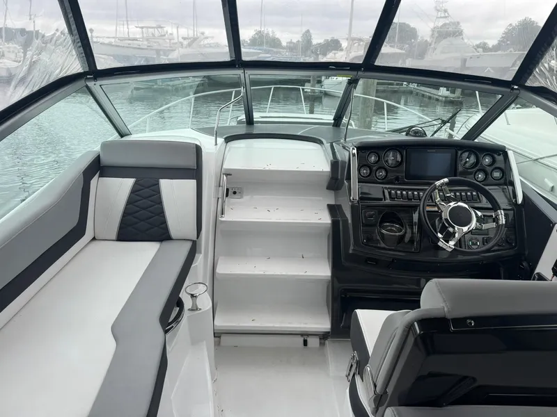 Slide: The Image of 2020 Monterey 295 Sport Yacht interior with modern helm and seating. - 12