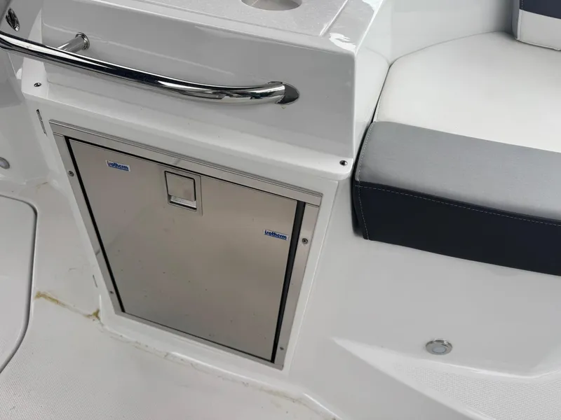 Slide: The Image of 2020 Monterey 295 Sport Yacht interior with stainless steel cabinet and cushioned seating. - 15