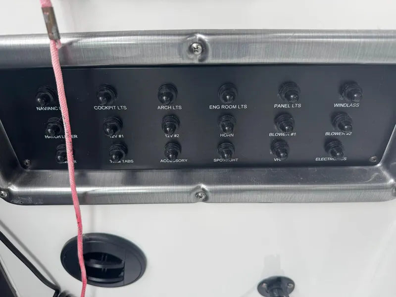 Slide: The Image of Control panel of a 2020 Monterey 295 Sport Yacht with labeled switches and buttons. - 17