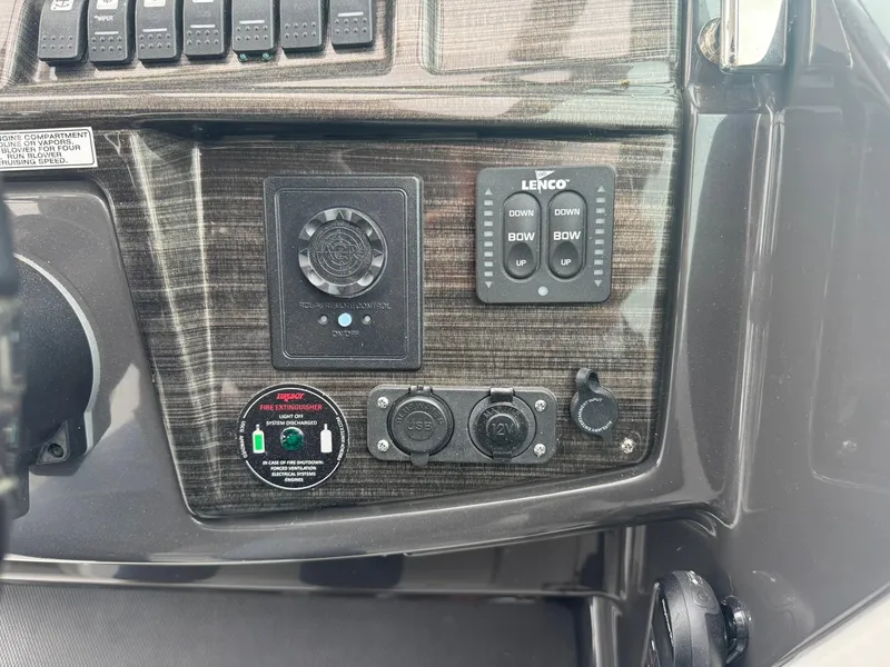 Slide: The Image of Control panel of a 2020 Monterey 295 Sport Yacht with various switches and dials. - 18