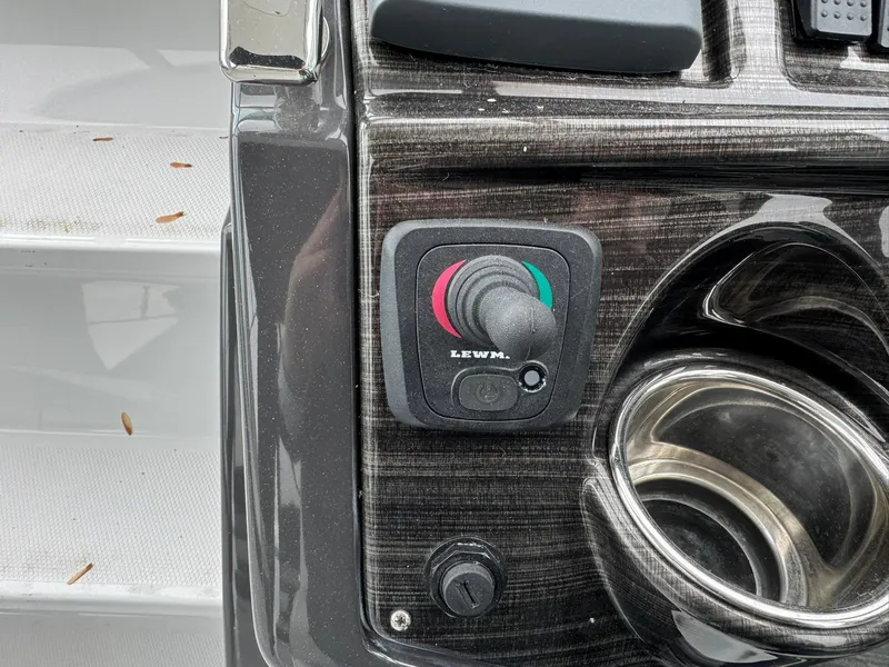 Slide: The Image of Control panel of a 2020 Monterey 295 Sport Yacht with joystick and cup holder. - 19