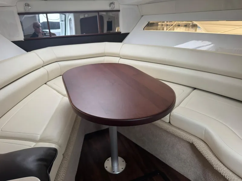 Slide: The Image of Interior of 2020 Monterey 295 Sport Yacht with elegant seating and wooden table. - 25