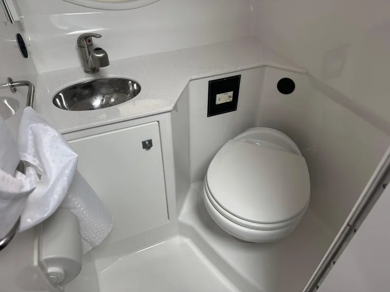 Slide: The Image of 2020 Monterey 295 Sport Yacht bathroom with sink and toilet. - 29