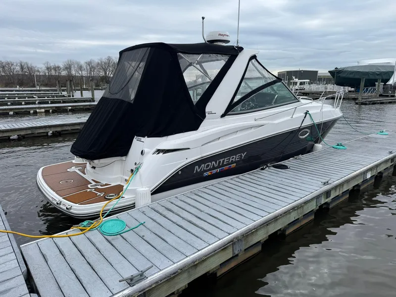 Slide: The Image of 2020 Monterey 295 Sport Yacht docked at marina with black canopy. - 7