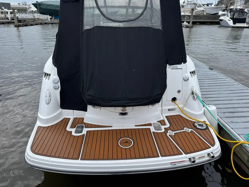 Slide: The Image of 2020 Monterey 295 Sport Yacht docked, featuring a sleek rear deck design. - 9