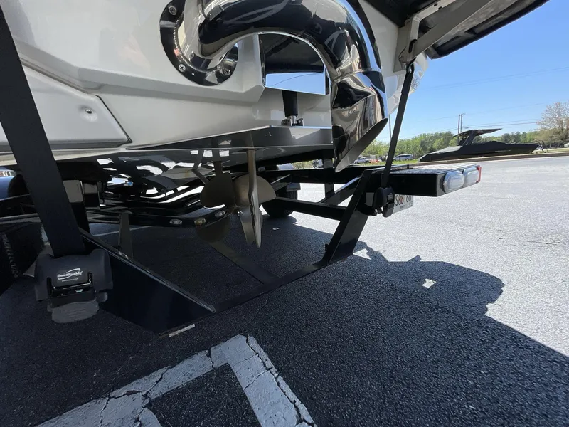 Slide: The Image of 2017 Nautique Super Air G23 boat propeller and trailer detail in parking lot. - 10