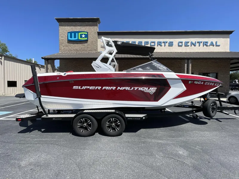Slide: The Image of 2017 Nautique Super Air G23 boat in red and white, parked at a dealership. - 12
