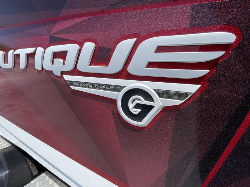 Slide: The Image of 2017 Nautique Super Air G23 logo on a sleek, red boat exterior. - 14