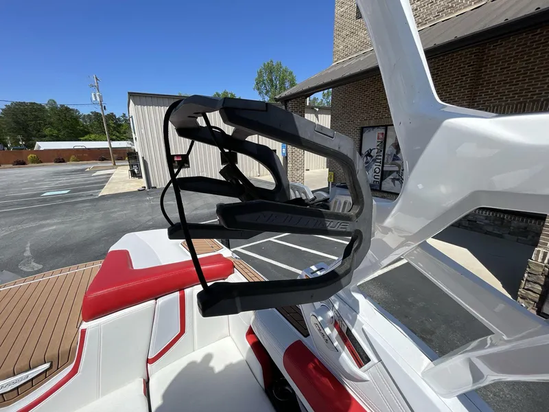 Slide: The Image of 2017 Nautique Super Air G23 boat with red and white interior, featuring a wakeboard rack. - 18