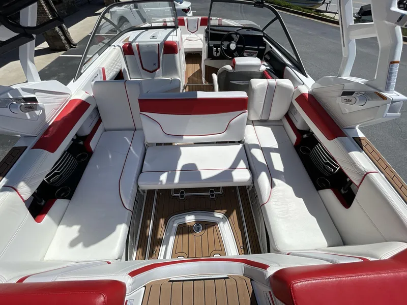 Slide: The Image of 2017 Nautique Super Air G23 boat interior with red and white seating, wood flooring. - 22