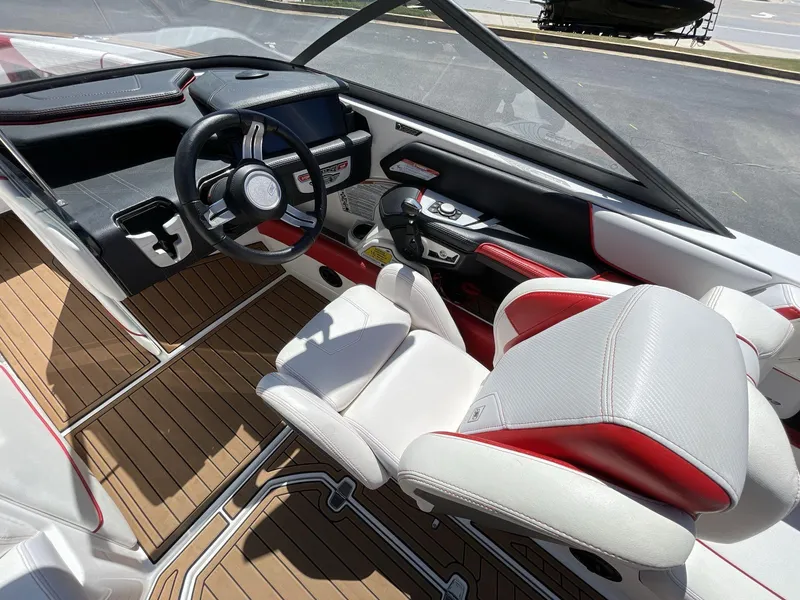 Slide: The Image of 2017 Nautique Super Air G23 boat interior with sleek dashboard and modern steering wheel. - 27