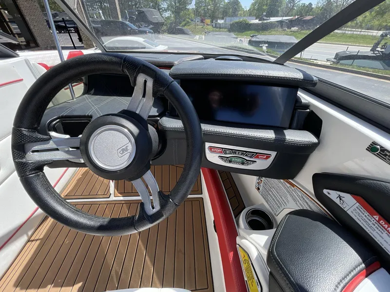 Slide: The Image of 2017 Nautique Super Air G23 boat interior with steering wheel and dashboard. - 29