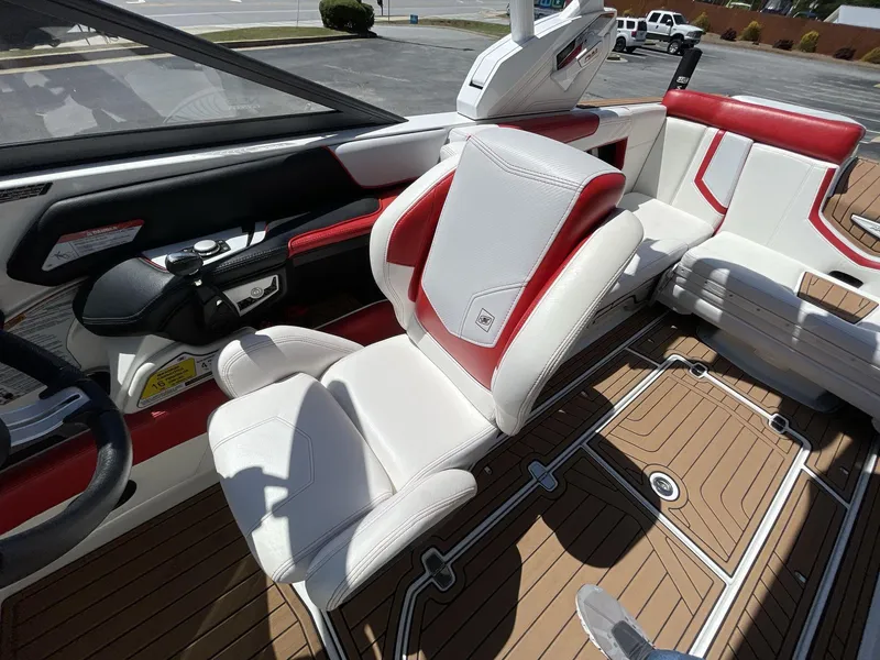 Slide: The Image of 2017 Nautique Super Air G23 interior with red and white seating, and teak flooring. - 30