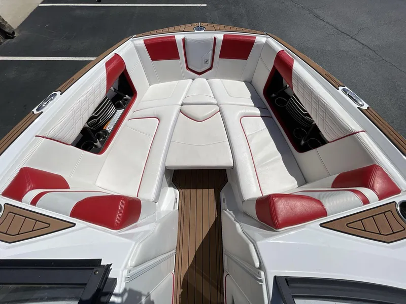 Slide: The Image of 2017 Nautique Super Air G23 boat interior with red and white seating. - 32