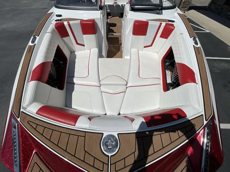 Slide: The Image of 2017 Nautique Super Air G23 boat interior with red and white seating and wood accents. - 34