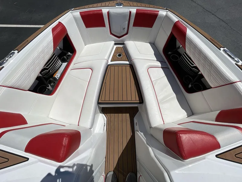 Slide: The Image of 2017 Nautique Super Air G23 boat interior with red and white seating and wood flooring. - 35