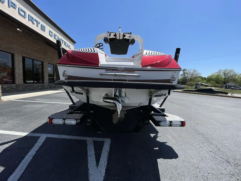 Slide: The Image of 2017 Nautique Super Air G23 boat, rear view, parked outdoors on sunny day. - 8