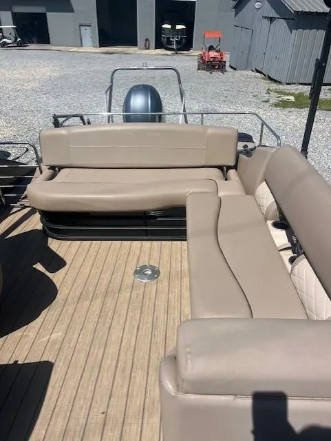 Slide: The Image of 2017 Bennington 24 SSBXP pontoon boat with beige seating and wooden deck. - 3