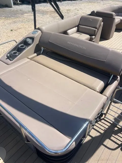 Slide: The Image of 2017 Bennington 24 SSBXP pontoon boat with beige seating and cup holders. - 5