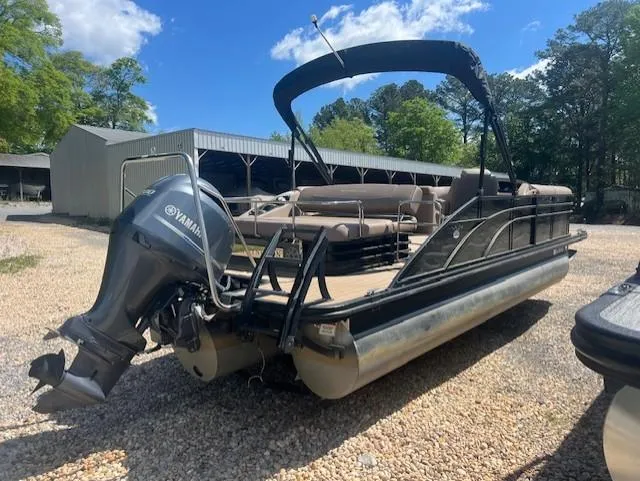 Slide: The Image of 2017 Bennington 24 SSBXP pontoon boat with Yamaha engine, parked on gravel. - 6