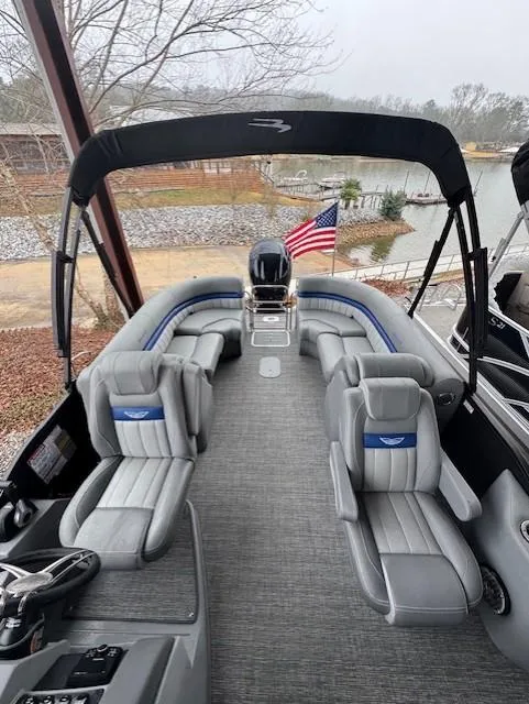 Slide: The Image of 2025 Bennington 24 LXSFB pontoon boat with luxurious seating and American flag. - 4
