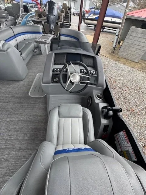 Slide: The Image of 2025 Bennington 24 LXSFB boat interior with modern steering console and seating. - 5