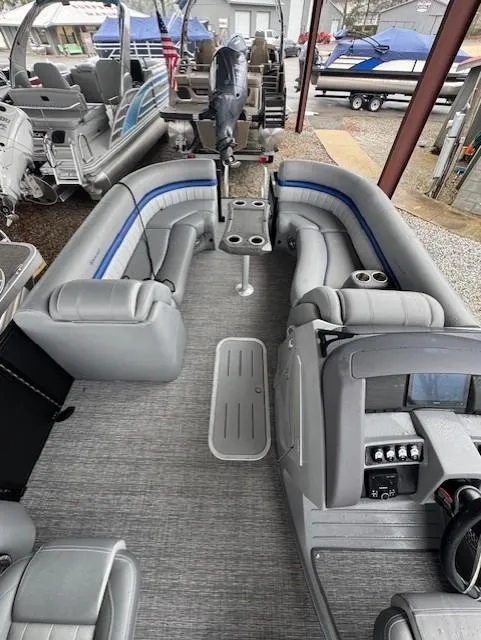 Slide: The Image of 2025 Bennington 24 LXSFB pontoon boat with spacious seating and modern interior design. - 6