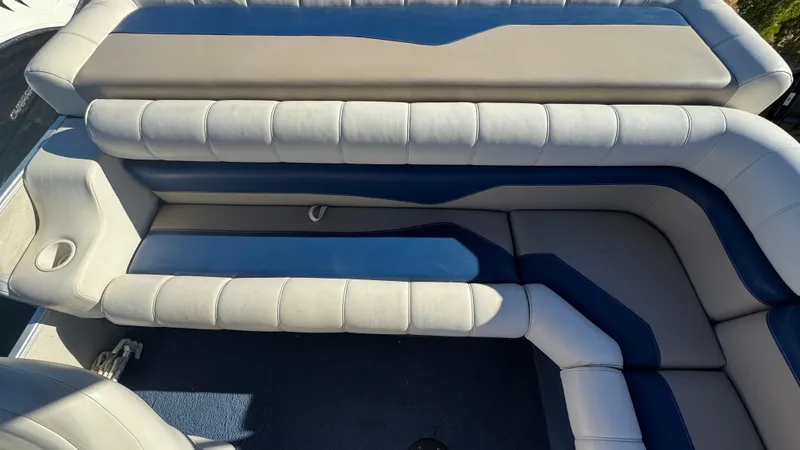 Slide: The Image of 2003 Godfrey Sweet Water boat interior with cushioned seating and blue accents. - 15