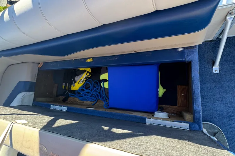 Slide: The Image of Storage compartment in a 2003 Godfrey Sweet Water boat with ropes and equipment. - 20