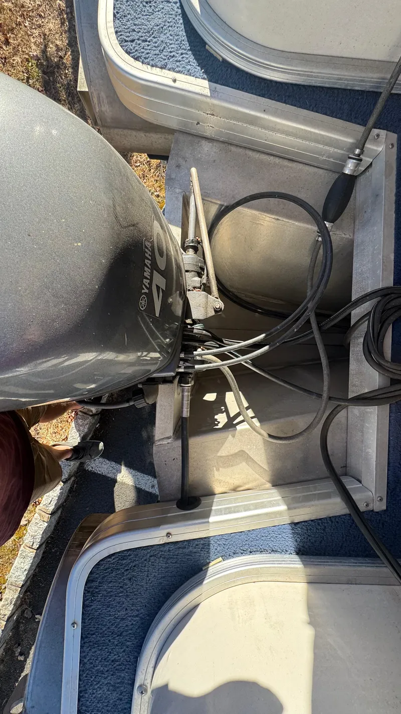 Slide: The Image of 2003 Godfrey Sweet Water boat engine and deck view. - 21